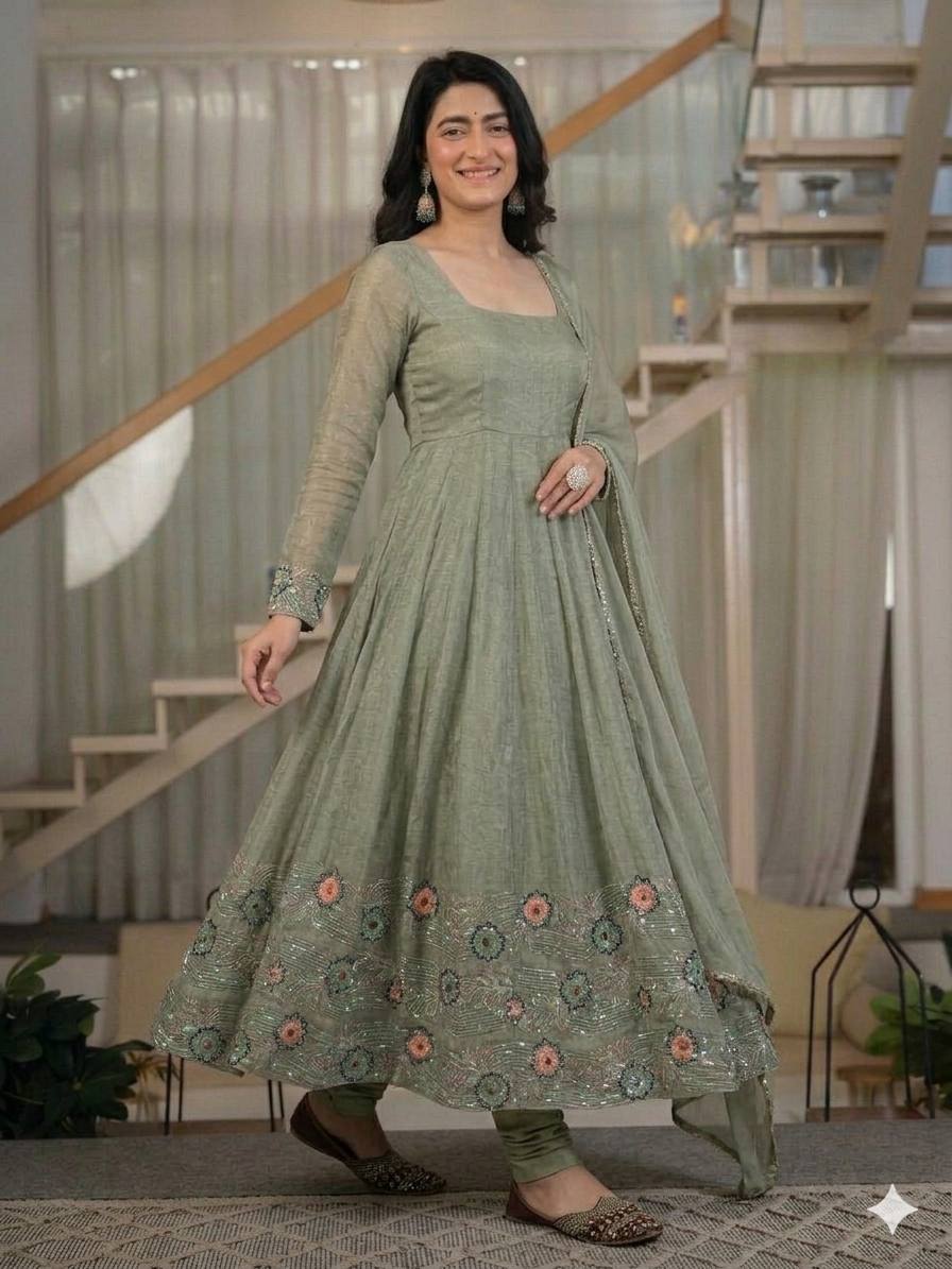Ethereal Mehendi Green Flared Anarkali Suit Set Adorned with Luminous Sequined Floral Motifs, Embroidered Cuffs, and an Ornate Heritage Hem